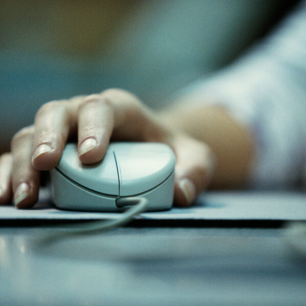 Close-up of a persons hand holding a computer mouse